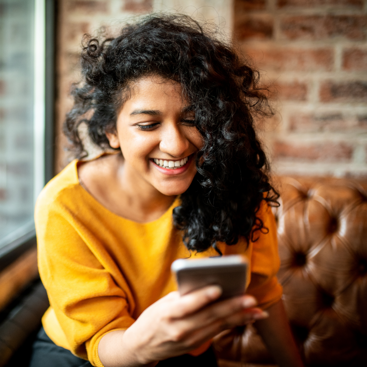 Image of woman smiling at her phone